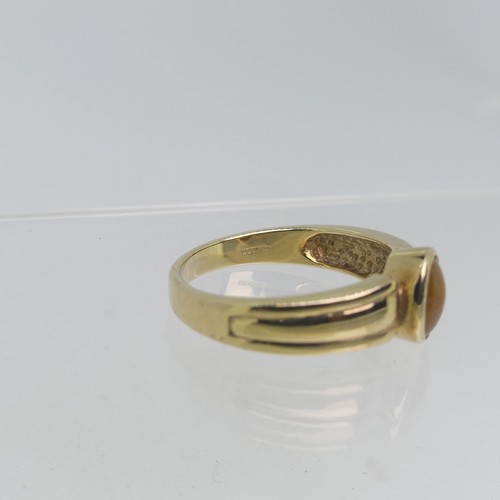 74 - A 9ct yellow gold Signet Ring, collet set with an oval Tiger's Eye, Size T, 4.5g.