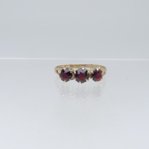 110 - Five 9ct yellow gold Rings; one set three garnets, Size O, one a sapphire and white paste triple clu... 