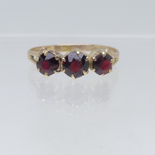 110 - Five 9ct yellow gold Rings; one set three garnets, Size O, one a sapphire and white paste triple clu... 