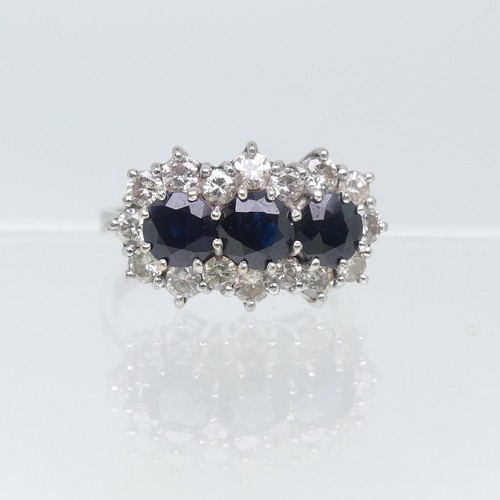 107 - A sapphire and diamond triple Cluster Ring, the three circular facetted sapphires surrounded by sixt... 