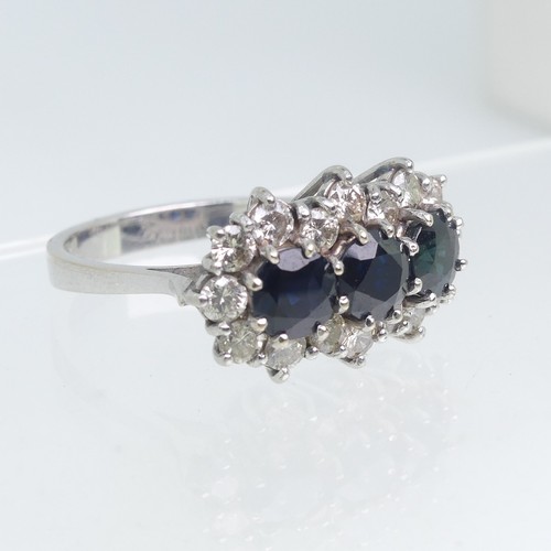 107 - A sapphire and diamond triple Cluster Ring, the three circular facetted sapphires surrounded by sixt... 