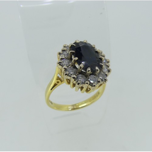 80 - A sapphire and diamond Cluster Ring, the oval facetted sapphire approx. 10mm x 6.8mm, surrounded by ... 