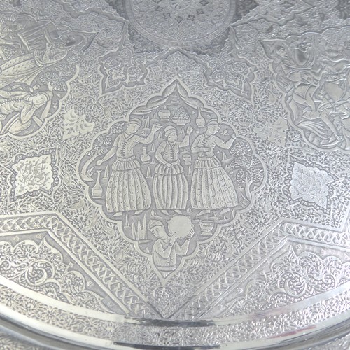 446 - An early 20thC Persian circular silver Tray, decorated with six figural scenes within a scrolling fo... 