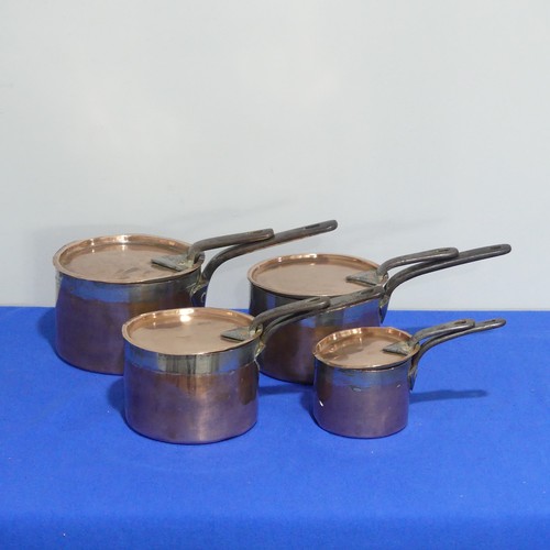 368 - A set of four graduated 19thC copper Saucepans, each graduating in size, with cast iron handles and ... 