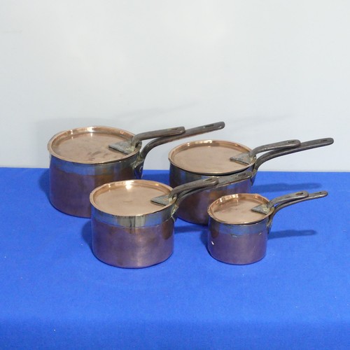 368 - A set of four graduated 19thC copper Saucepans, each graduating in size, with cast iron handles and ... 