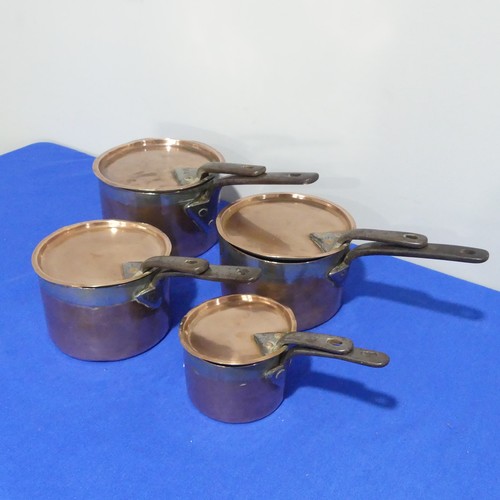 368 - A set of four graduated 19thC copper Saucepans, each graduating in size, with cast iron handles and ... 