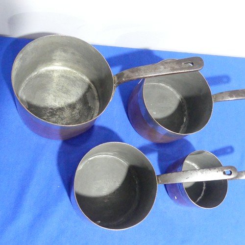 368 - A set of four graduated 19thC copper Saucepans, each graduating in size, with cast iron handles and ... 