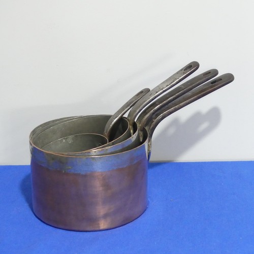 368 - A set of four graduated 19thC copper Saucepans, each graduating in size, with cast iron handles and ... 