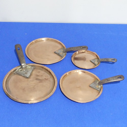 368 - A set of four graduated 19thC copper Saucepans, each graduating in size, with cast iron handles and ... 