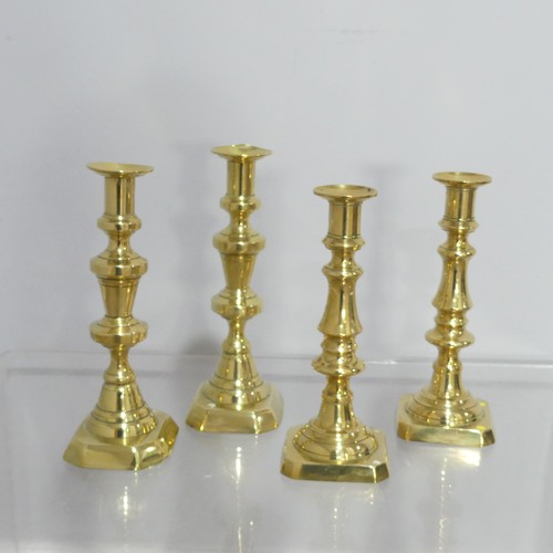 372 - Two pairs antique turned brass Candlesticks, on square and hexagonal bases, dents to sconce, Highest... 