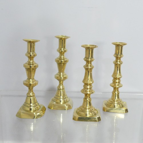 372 - Two pairs antique turned brass Candlesticks, on square and hexagonal bases, dents to sconce, Highest... 