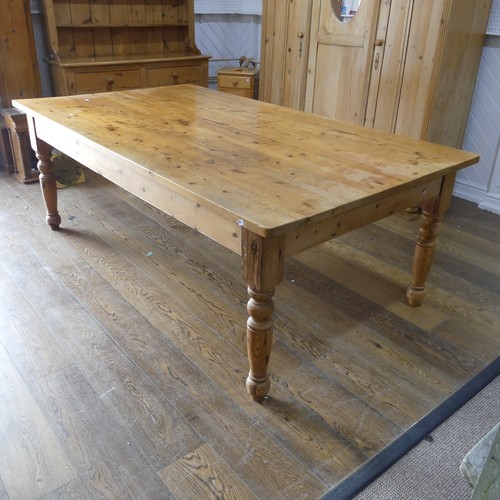 382 - A pine farmhouse Kitchen Table, with rounded corners, on turned legs, some mouse damage to one leg, ... 