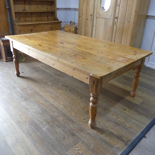 382 - A pine farmhouse Kitchen Table, with rounded corners, on turned legs, some mouse damage to one leg, ... 