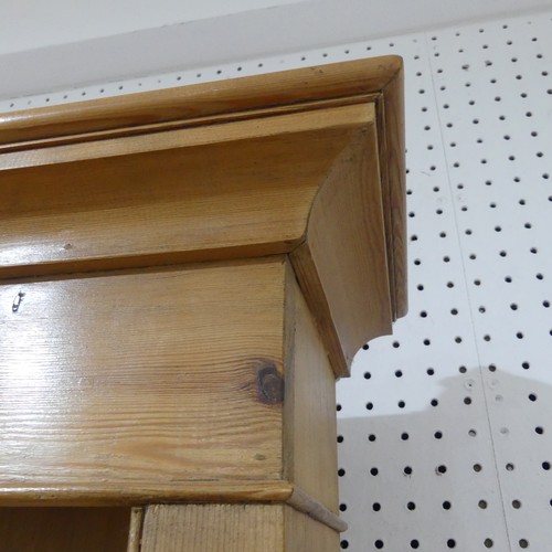 383 - An antique pine kitchen Dresser, with moulded cornice above a three tier plate rack, with two drawer... 