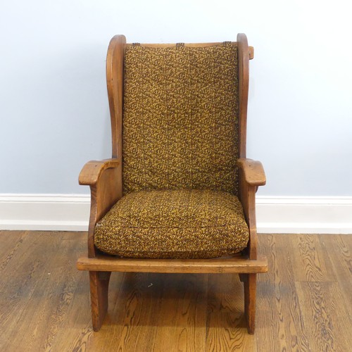 401 - A pair of Arts & Crafts elm 'Lambing Chairs', with shaped back and arm rests, raised upon shaped... 