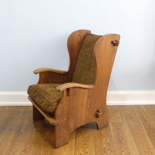 401 - A pair of Arts & Crafts elm 'Lambing Chairs', with shaped back and arm rests, raised upon shaped... 