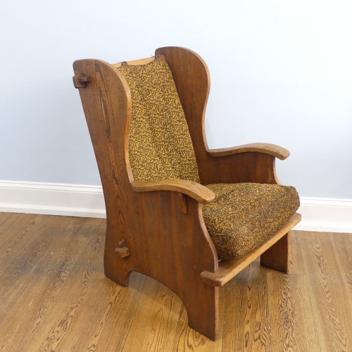 401 - A pair of Arts & Crafts elm 'Lambing Chairs', with shaped back and arm rests, raised upon shaped... 