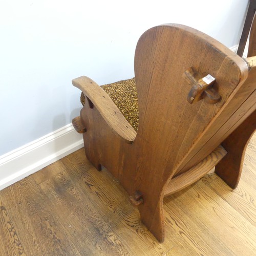 401 - A pair of Arts & Crafts elm 'Lambing Chairs', with shaped back and arm rests, raised upon shaped... 