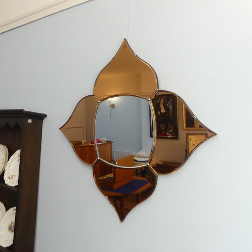 404 - An Art Deco coloured glass 'Petal' Wall Mirror, with four peach coloured petals surrounding a clear ... 