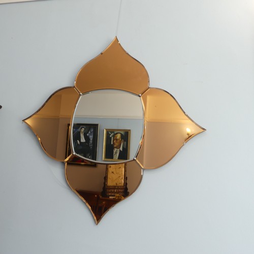 404 - An Art Deco coloured glass 'Petal' Wall Mirror, with four peach coloured petals surrounding a clear ... 