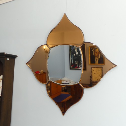 404 - An Art Deco coloured glass 'Petal' Wall Mirror, with four peach coloured petals surrounding a clear ... 