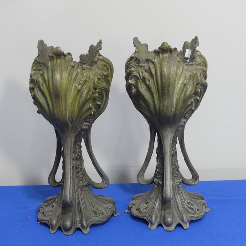 407 - A pair of Art Nouveau spelter Vases, of three handled form, moulded with floral decoration on shaped... 