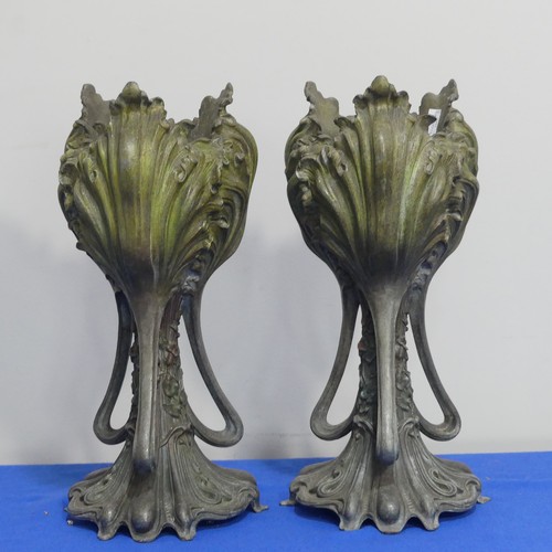 407 - A pair of Art Nouveau spelter Vases, of three handled form, moulded with floral decoration on shaped... 