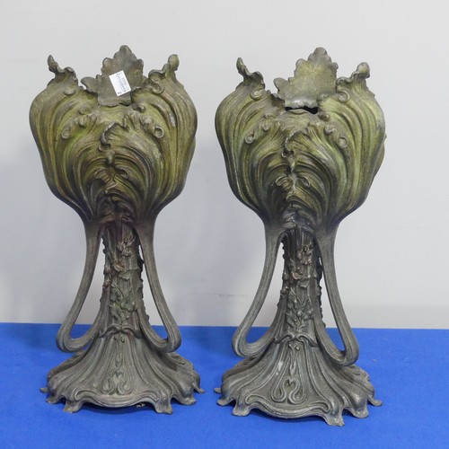 407 - A pair of Art Nouveau spelter Vases, of three handled form, moulded with floral decoration on shaped... 