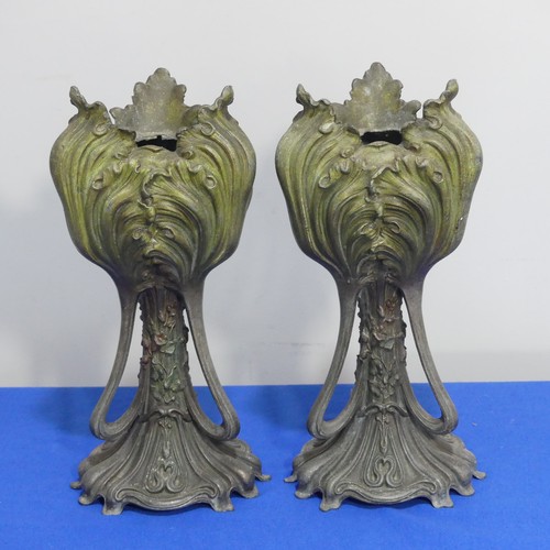 407 - A pair of Art Nouveau spelter Vases, of three handled form, moulded with floral decoration on shaped... 