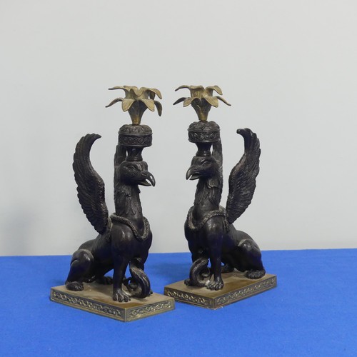 416 - A pair of 19thc style classical Candlesticks, each modelled as a gryphon, on brass base, H 27cm.... 