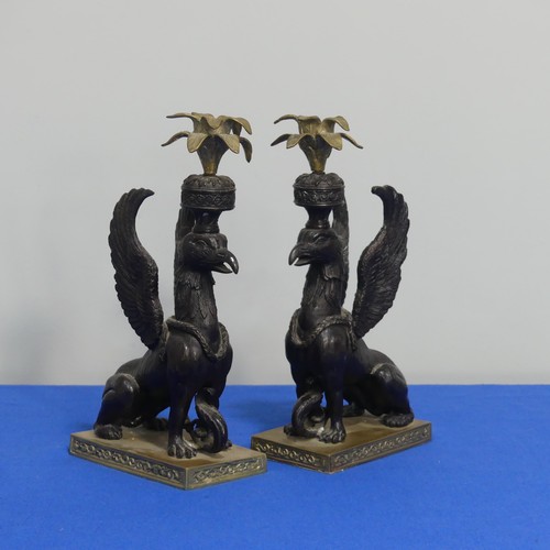 416 - A pair of 19thc style classical Candlesticks, each modelled as a gryphon, on brass base, H 27cm.... 