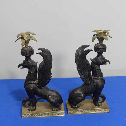 416 - A pair of 19thc style classical Candlesticks, each modelled as a gryphon, on brass base, H 27cm.... 