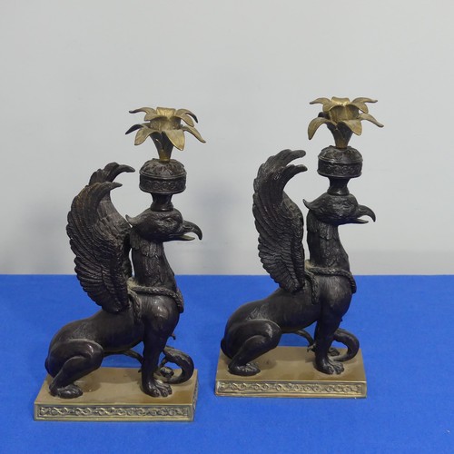 416 - A pair of 19thc style classical Candlesticks, each modelled as a gryphon, on brass base, H 27cm.... 