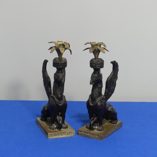 416 - A pair of 19thc style classical Candlesticks, each modelled as a gryphon, on brass base, H 27cm.... 