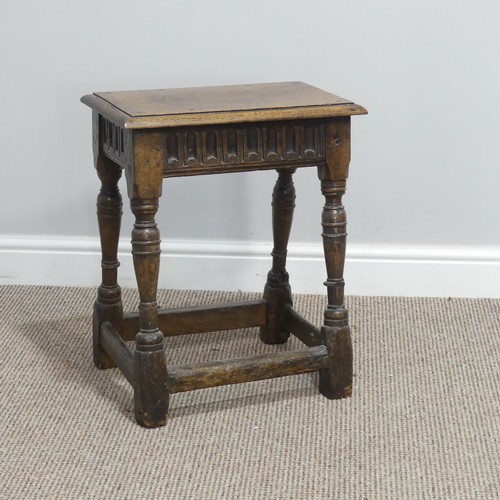 432 - An antique oak joint Stool, the rectangular seat with moulded edges, above a carved frieze, raised o... 