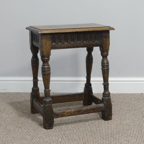 432 - An antique oak joint Stool, the rectangular seat with moulded edges, above a carved frieze, raised o... 