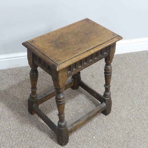 432 - An antique oak joint Stool, the rectangular seat with moulded edges, above a carved frieze, raised o... 