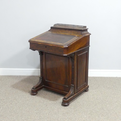 434 - A Victorian walnut Davenport, the rectangular top with galleried stationery compartment, lifting to ... 