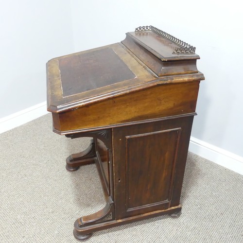 434 - A Victorian walnut Davenport, the rectangular top with galleried stationery compartment, lifting to ... 