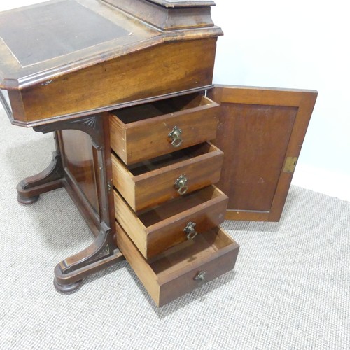 434 - A Victorian walnut Davenport, the rectangular top with galleried stationery compartment, lifting to ... 