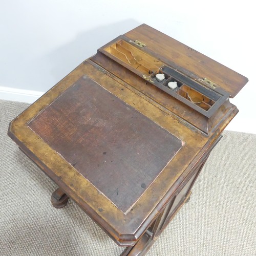 434 - A Victorian walnut Davenport, the rectangular top with galleried stationery compartment, lifting to ... 