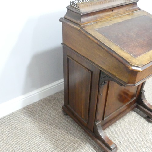 434 - A Victorian walnut Davenport, the rectangular top with galleried stationery compartment, lifting to ... 