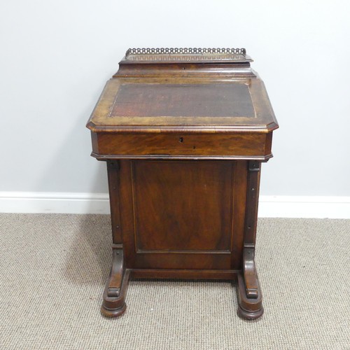 434 - A Victorian walnut Davenport, the rectangular top with galleried stationery compartment, lifting to ... 