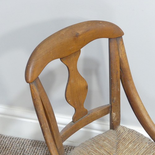 441 - A 20thC  rush seated child's Chair, with shaped back and rush seat supported on stretchers, split to... 