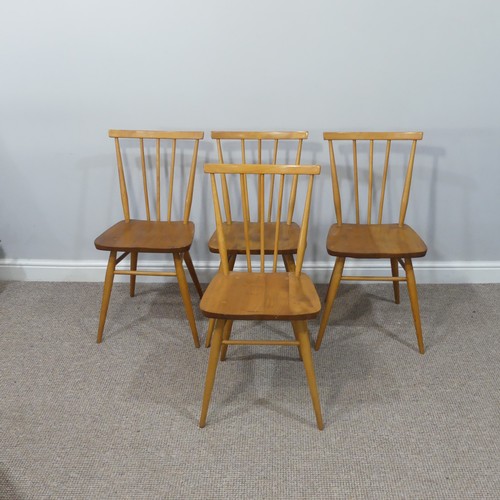 454 - A set of four vintage Ercol stick back Dining Chairs, having a rounded seat and stick backrest attac... 