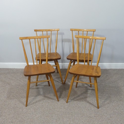 454 - A set of four vintage Ercol stick back Dining Chairs, having a rounded seat and stick backrest attac... 