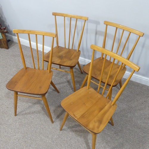 454 - A set of four vintage Ercol stick back Dining Chairs, having a rounded seat and stick backrest attac... 