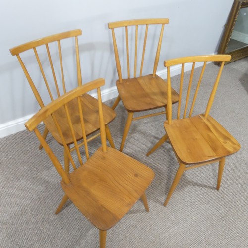 454 - A set of four vintage Ercol stick back Dining Chairs, having a rounded seat and stick backrest attac... 