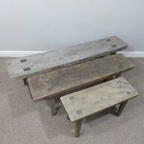 460 - A set of three rustic oak Benches, of graduating  size on splayed legs, one carved with initials HB ... 