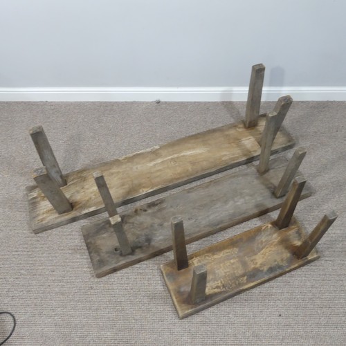 460 - A set of three rustic oak Benches, of graduating  size on splayed legs, one carved with initials HB ... 